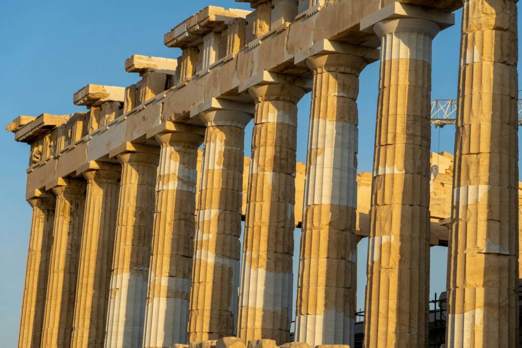 Columns of the Parthenon on the Acropolis of Athens against a blue sky
